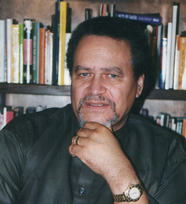 Dr. Asa G. Hilliard III seated in his study